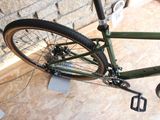 a bike that is sitting on the floor in front of a brick wall