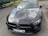 a black car that is parked on the side of the road