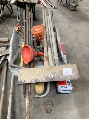 a pile of tools sitting on the ground in a garage