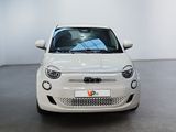 a small white car that is parked in a room