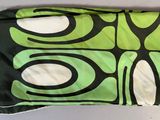 a green and black bag with a black and white design on it
