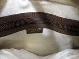 the inside of a white purse with a brown zipper