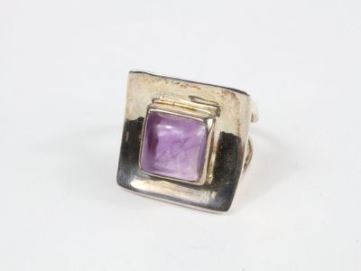 Gros plan sur une bague contenant une pierre violette