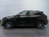 the bmw x6 is parked on a concrete surface