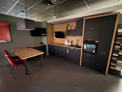 a room with a table, chairs, and a television in it