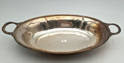 an antique silver plate with handles and handles on a table