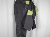 grey and green pants hanging on a hanger in front of a white curtain