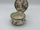 an image of a small white bowl with flowers on it