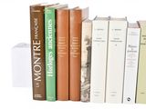many books that are lined up on a shelf