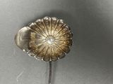 an antique silver spoon with a flower on top of it