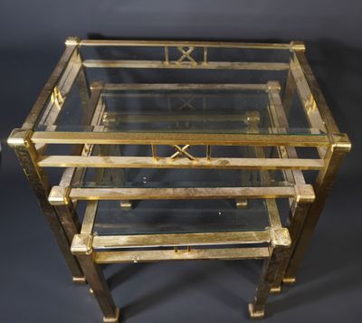 a brass and glass coffee table with three shelves
