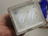 a person holding a small box with a pair of scissors on it
