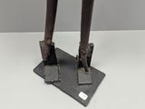 a close up of a statue of a person standing on a base