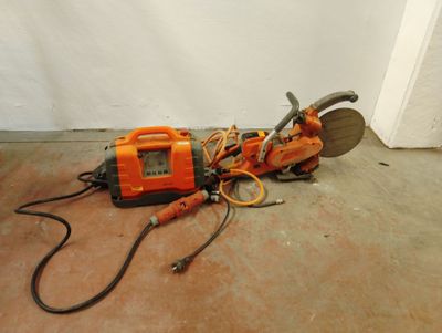 une machine orange et noire qui est posée par terre