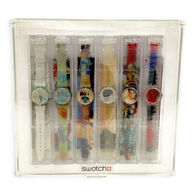 six watches in a clear case on a white background