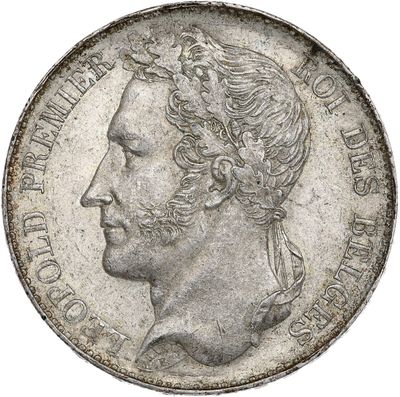 a close up of a coin with a man ' s face on it