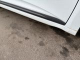 a white car parked on the side of the road