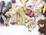a lot of dolls that are laying on the floor