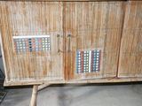 a wooden cabinet that has a lot of buttons on it