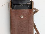 a brown leather case with a cell phone inside of it