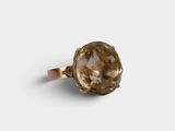 a close up of a ring with a brown stone on it