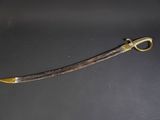 an old sword with a gold handle on a black surface