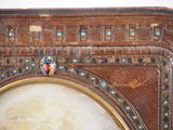 a close up of a clock with a decorative decoration on it