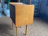 a small wooden table with a drawer on top of it