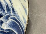 a blue and white plate with a bird on it