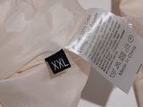 a close up of a white shirt with a label on it