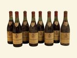 six bottles of wine are lined up in a row on a white background
