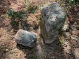 two large rocks sitting on the ground next to each other
