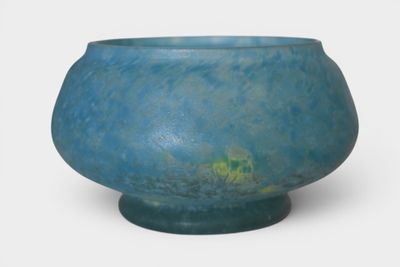 a blue vase with a green base on a white background