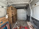 a white van with a lot of wood in the back