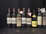 several bottles of wine are lined up on a table