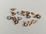 several different types of clasps and rings on a white surface