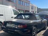 a black sports car parked in front of a building