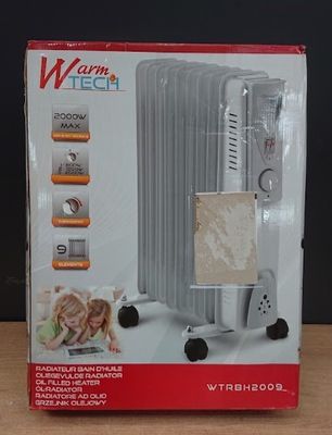 packaging of a white electric heater sitting on top of a wooden table