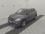 a grey volkswagen suv parked in a garage with a checkered floor