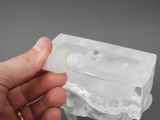 a person holding a piece of ice in their hand
