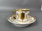 an image of a cup and saucer with a gold rim