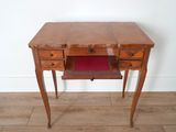 a small wooden desk with a drawer on top of it