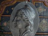 a statue of a woman hanging from the ceiling