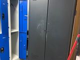 two lockers in the middle of a room with blue doors