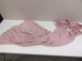 a pink and white striped shirt on a white table