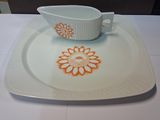 a white plate with a saucer and a bowl on it