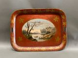 a red tray with a painting of a river scene on it