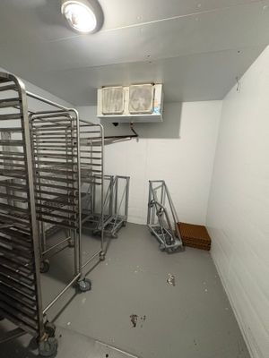 a room with a bunch of racks of food in it