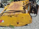 an image of a yellow machine that is sitting in the gravel