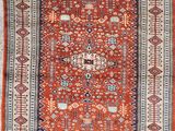 an orange and blue rug with a medallion design